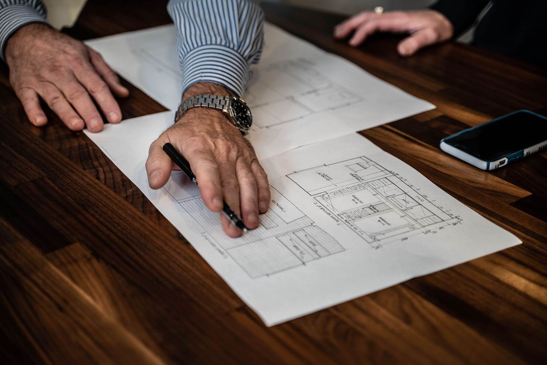 mason going over floorplans during the great renovation surge